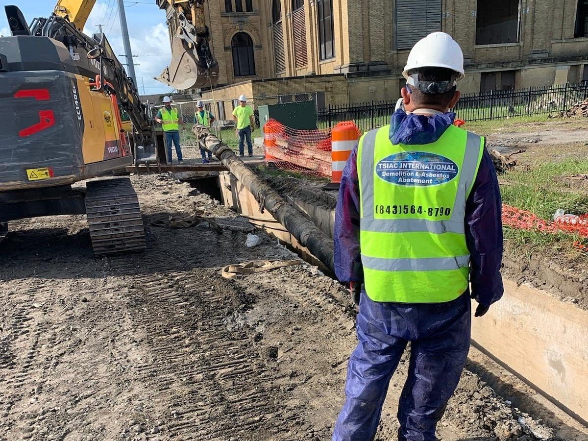 TSIAC International crew member in a branded safety vest on a job site