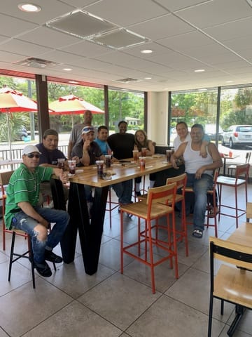 The TSIAC International crew together at a restaurant table